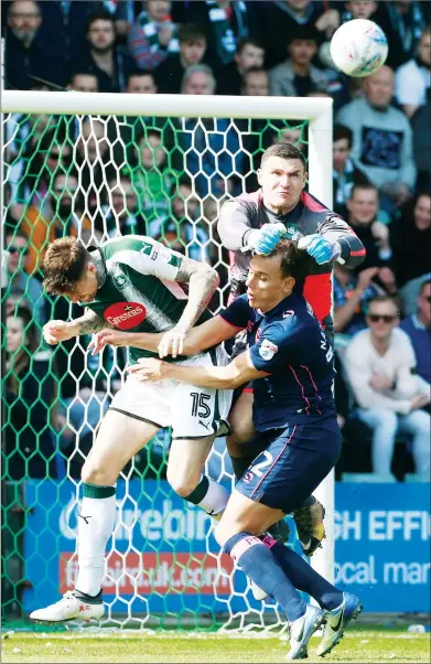  ??  ?? FISTS OF FURY: Plymouth goalkeeper Kyle Letheren punches clear