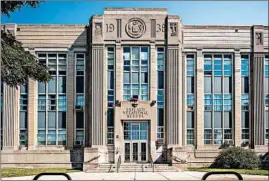  ??  ?? Lee Bey, former architectu­re critic of the Chicago Sun-Times, takes notice of several schools on the South Side, including Chicago Vocational High School, 2100 E. 87th St.