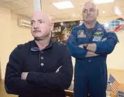  ?? DMITRY LOVETSKY AP File, 2015 ?? U.S. astronaut Scott Kelly, right, stands in a quarantine room, behind his brother, Mark, after a mission to the Internatio­nal Space Station in the Kazakhstan cosmodrome.