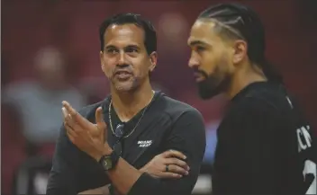  ?? REBECCA BLACKWELL/AP ?? MIAMI HEAT HEAD COACH ERIK SPOELSTRA, left, talks with Miami Heat guard Gabe Vincent during a practice ahead of Game 3 of the NBA Finals, at the Kaseya Center in Miami on Tuesday.