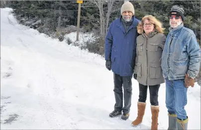  ?? NIKKI SULLIVAN/CAPE BRETON POST ?? Gene Kersey, from left, Heather Hayes and Tim Menk, all directors of Friends of Gabarus Society, stand at the start of Oceanview Road. The road ends at the Louisbourg-Gabarus road, which closed in the mid-1960s. It is part of the Fleur-de-Lis Trail and...