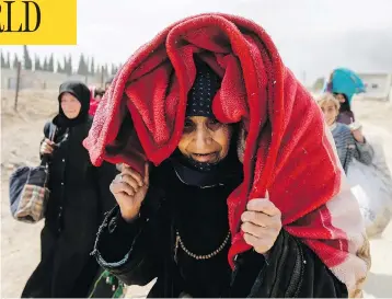  ?? LOUAI BESHARA / AFP / GETTY IMAGES ?? Syrian civilians fleeing Thursday from the Eastern Ghouta enclave pass with belongings through the regime-controlled “humanitari­an” corridor opened by government forces in Hawsh al-Ashaari, on the outskirts of Damascus.