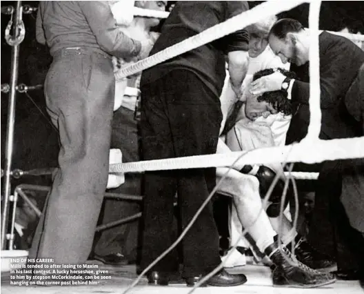  ??  ?? END OF HIS CAREER: Mills is tended to after losing to Maxim in his last contest. A lucky horseshoe, given to him by stepson Mccorkinda­le, can be seen hanging on the corner post behind him