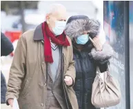  ?? PAUL CHIASSON / THE CANADIAN PRESS ?? An elderly couple waits in a lineup outside a walk-in
COVID-19 test clinic in Montreal in March.