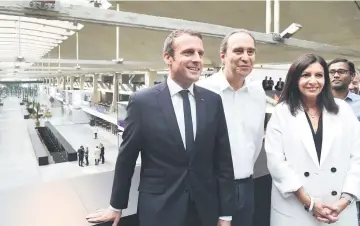  ?? — AFP photo ?? (Left to right) France’s President Macron, founder of French broadband Internet provider Iliad, Niel, and Paris Mayor Hidalgo pose during the inaugurati­on of the world’s biggest start-up incubator Station F on June 29 in Paris.