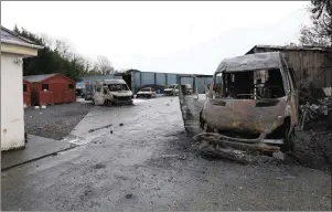  ??  ?? Some of the burned out vans and cars in the yard of the house which was the scene of an eviction in Strokestow­n last week. Pic: Brian Farrell.