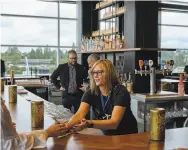  ?? Ian C. Bates / New York Times ?? The bar at Alaska Airlines’ new lounge at SeattleTac­oma Internatio­nal Airport in Seattle.