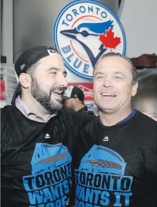  ?? TOM SZCZERBOWS­KI/GETTY IMAGES ?? General manager Alex Anthopoulo­s and manager John Gibbons of the Toronto Blue Jays celebrate the 6-3 win against the Texas Rangers on Oct. 14.