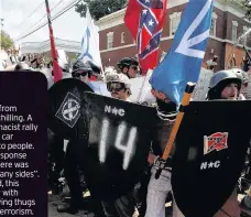 ??  ?? MAYHEM Ugly scenes at white race hate rally ended in death and injury. Picture: Joshua Roberts THE images from Virginia are chilling. A white supremacis­t rally ended with a car ploughing into people.
Trump’s response was to say there was “blame on...