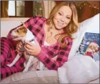  ??  ?? There’s no escape from Mariah Carey’s All I want for Christmas. It became a book and now it is being made into a movie. Even the dog wants to get away.