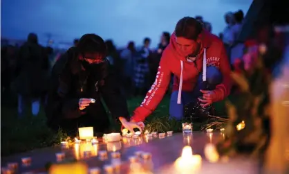  ??  ?? Women at a vigil for the victims of the mass shooting in Keyham, Plymouth. Photograph: Ben Birchall/PA