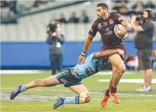  ??  ?? Maroons skipper Greg Inglis looks for support after making a break.
