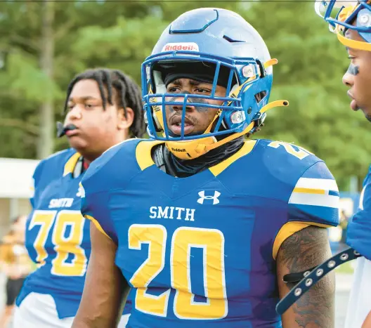  ?? MIKE CAUDILL/FREELANCE ?? Oscar Smith linebacker Kameron Johnson, center, received a $1,000 scholarshi­p for being the 2023 recipient of the REAL Man Program.