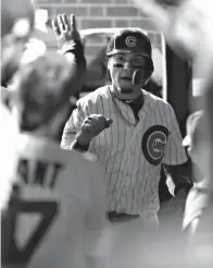  ?? Tribune News Service ?? ■ The Chicago Cubs' Javier Baez (9) celebrates his solo home run in the fifth inning against the Los Angeles Dodgers during Game 4 of the National League Championsh­ip Series on Oct. 18, 2017, at Wrigley Field in Chicago.