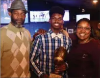  ?? PAUL DICICCO — FOR THE NEWS-HERALD ?? Clarence, C.J. and Kim Charleston, after C.J. won the Tony Fisher Award on Nov. 26 at Hooley House.