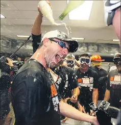  ?? ASSOCIATED PRESS ?? CARLOS OSORIO Detroit pitcher Max Scherzer gets a champagne bath in the locker room after the Tigers clinched their fourth consecutiv­e AL Central Division title.