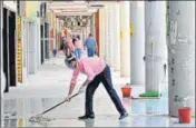  ?? SANJEEV SHARMA & RAVI KUMAR/H ?? A man cleaning the corridor before opening a shop at the Plaza; (below) workers’ cycles parked against a wall, as shopkeeper­s hoped for their business to kick off under lockdown 4.0, in Sector 17, Chandigarh, on Tuesday.