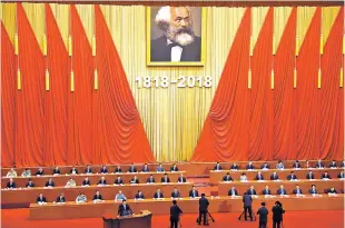  ?? NG HAN GUAN/THE ASSOCIATED PRESS ?? Chinese President Xi Jinping, bottom, speaks Friday at the podium during an event to mark the bicentenni­al of Karl Marx’s birth at the Great Hall of the People in Beijing. Xi praised Marx as ‘the greatest thinker of modern times.’