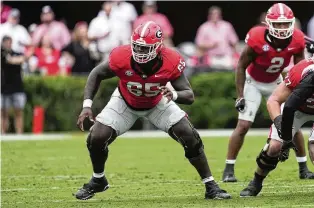  ?? JOHN BAZEMORE / AP ?? Georgia offensive tackle Amarius Mims pass blocks aginst South Carolina last September. The Bengals see great potential in their 6-foot-7, 340-pound first-round draft pick.