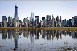  ?? MEL EVANS — THE ASSOCIATED PRESS FILE ?? New York’s Lower Manhattan skyline, including the One World Trade Center, left, is seen from Liberty State Park in Jersey City, N.J.