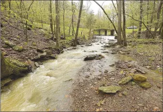  ??  ?? Arkansas 103 between Oark and Clarksvill­e isn’t a designated scenic byway, but the drive is beautiful nonetheles­s. Road trippers can see rivers, creeks and waterfalls from the car along a stretch through the Ozark National Forest. (NWA Democrat-Gazette/Flip Putthoff)