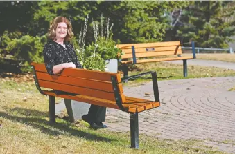  ?? GAVIN YOUNG ?? Shauna Caldwell sits at the memorial benches for twin sons Evan and Jordan Caldwell, who died in an accident at Canada Olympic Park in 2016. She is writing a multi-part series of articles on dealing with grief.