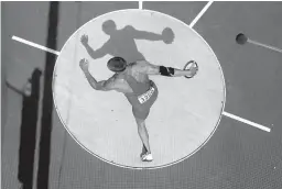  ?? Associated Press ?? n United States' Trey Hardee competes in the men's decathlon discus throw event Aug. 9, 2012, at the London 2012 Olympic Games. Hardee wants to set the record straight: No, he's not retired. Never has been. The two-time world champion decathlete...