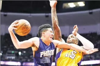  ??  ?? Phoenix Suns guard Brandon Knight fends off Los Angeles Lakers forward Thomas Robinson on a drive for a shot
during the second half of an NBA preseason basketball game in Anaheim, California on Oct 21. (AP)