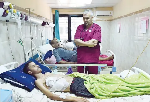  ??  ?? Algerian doctor Bougroura (right), head of nephrology department at Batna’s university hospital, talks to a transplant patient. In Algeria and across the entire Maghreb in North Africa, many people continue to suffer or die because of the lack of...