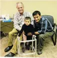  ??  ?? Now fitted with a prosthetic leg, Yahya is able to walk and run. He is pictured here with Dr. Ben Allen and his father Dawod Mohammed.