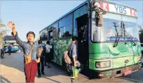  ?? PHOTO: REUTERS ?? All aboard . . . An assistant driver waves to passengers in Yangon, Myanmar, yesterday.