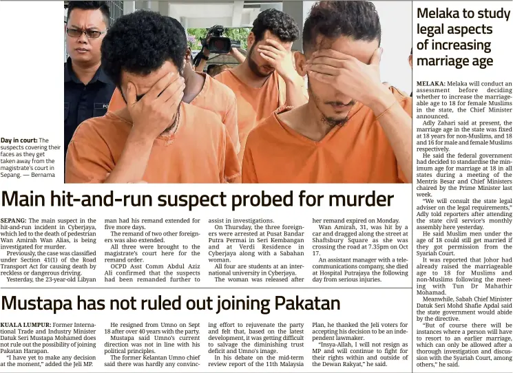  ?? — Bernama ?? Day in court: The suspects covering their faces as they get taken away from the magistrate’s court in Sepang.