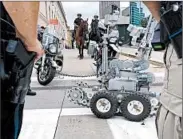  ?? MICHAEL MATHES/GETTY-AFP ?? Cleveland police show security assets, including remotecont­rolled robots, last week ahead of the GOP convention.