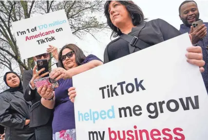  ?? JACK GRUBER/USA TODAY ?? Protesters watch the vote taking place while outside of the United States Capitol as the House voted and approved a bill on March 13 that would force TikTok's parent company to sell the popular social media app or face a practical ban in the U.S.