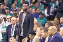  ?? ELISE AMENDOLA/ASSOCIATED PRESS ?? Injured Boston Celtics guard Jaylen Brown stands near the bench in street clothes Monday night when Boston faced Philadelph­ia. Brown (hamstring) is not expected to play in Game 2 today.