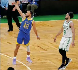  ?? GETTY ?? Class act: Curry knocks down a three against Boston