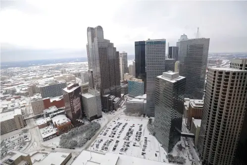  ?? Michael Heiman/Getty Images/TNS ?? ■ A snow-covered skyline can be seen from the 37th floor of the Sheraton Dallas on Feb. 4, 2011. The Dallas suburb of Arlington offers Via on-demand rideshare services in lieu of public transporta­tion. Like Uber or Lyft, passengers can hail a Via ride using an app on their smartphone. But unlike those services, Via won’t pick passengers up at their doorstep but will provide a pickup location within a short walk.