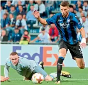  ?? —AP ?? Wayne Rooney of English club Everton falls to the ground as Atalanta’s Hans Hateboer gets to the ball during their Europa League match at the Mapei Stadium in Reggio Emilia, Italy, on Thursday. Everton lost 0-3.