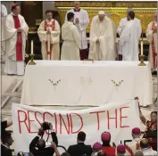  ?? GREGORIO BORGIA — THE ASSOCIATED PRESS ?? People display a banner during Pope Francis Mass at the National Shrine of Saint Anne de Beaupré in Quebec City, Canada, on Thursday, It reads “Rescind the Doctrine.”