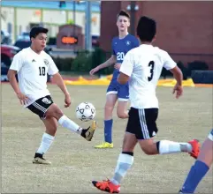  ?? Photos by TIM GODBEE / For the Calhoun Times ?? ( Calhoun’s Elmer Gutierrez (10) controls the ball while teammate Alex Aguilar (3) looks for the pass. ( Calhoun’s Eric Garcia (7) wins a header over a Ringgold defender.