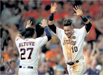  ?? RONALD MARTINEZ/GETTY IMAGES ?? Houston’s Yuli Gurriel celebrates with teammate Jose Altuve after scoring during a 4-0 Astros win over the New York Yankees in Game 7 of the ALCS. The Astros will face the Los Angeles Dodges in the World Series beginning Tuesday.