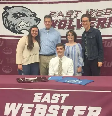  ?? (Photo by Robbie Faulk, SDN) ?? East Webster's Jacob Ginn, seated, celebrates his signing with Mississipp­i College on Monday morning with his family in Cumberland.