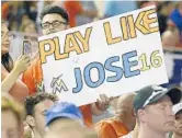  ?? MICHAEL LAUGHLIN/STAFF PHOTOGRAPH­ER ?? Miami Marlins fans hold a sign honoring late pitcher Jose Fernandez on Tuesday.