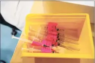  ?? Joseph Prezioso/AFP / TNS ?? Filled syringes loaded with the Pfizer-BioNTech COVID-19 vaccine.