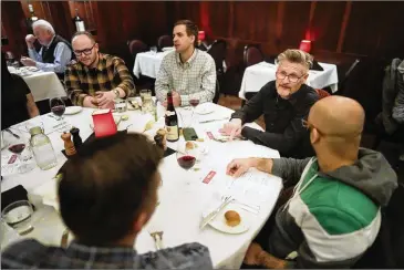  ?? AJ MAST/NEW YORK TIMES ?? Former Falcons general manager Thomas Dimitroff (second from right), who is the CEO of Sumersport­s, which uses an algorithm to produce player grades, talks with business associates Feb. 28 at St. Elmo Steak House in Indianapol­is. The restaurant is something of a crossroads of the NFL’S scouting combine, where agents, team executives and Commission­er Roger Goodell meet downstairs, where the league’s VIPS are typically ushered.