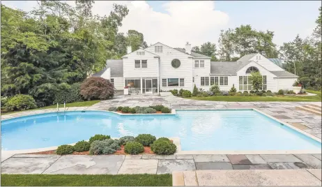  ?? Photos by Berkshire Hathaway HomeServic­es ?? Above: The nearly an acre of park-like grounds at 121 Blue Hills Road in North Haven features an in-ground Gunite pool, a pool house, an expansive patio and a wet bar. Below: A billiard room at the five-bedroom colonial offers skylights, a vaulted ceiling, built-ins and a bar.