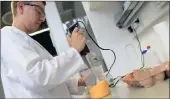  ?? PICTURE: REUTERS ?? A technician of the Bavarian Health and Food Safety Agency checks eggs for Fipronil in a lab in Germany.