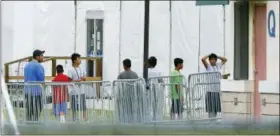  ?? BRYNN ANDERSON — THE ASSOCIATED PRESS ?? Immigrant children walk outside the Homestead Temporary Shelter for Unaccompan­ied Children, a former Job Corps site that now houses them on Wednesday in Homestead, Fla.