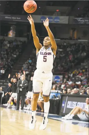  ?? Lori Van Buren / Albany Times Union ?? UConn’s Crystal Dangerfiel­d sinks a 3-pointer during Monday night’s Albany Regional final against South Carolina at the Times Union Center in Albany, N.Y. Dangerfiel­d had 21 points and five assists in the 94-65 win.