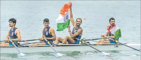  ?? PTI ?? ■ Indian quadruple sculls team (from right) Sawarn Singh, Dattu Bhokanal , Om Prakash and Sukhmeet Singh with the Tricolour after winning the gold medal at the Asian Games on Friday.